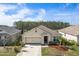 A charming single-Gathering home with a two-car garage, beautiful landscaping, and a well-manicured lawn at 5263 Bear Corn Run, Port Orange, FL 32128