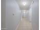 Light-filled hallway with tiled flooring, arched entryways, and access to various rooms at 5263 Bear Corn Run, Port Orange, FL 32128