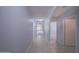 Inviting hallway with tile flooring that leads to carpeted rooms and an arched doorway at 5263 Bear Corn Run, Port Orange, FL 32128