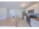 Bright kitchen boasts stainless steel appliances and an expansive island, creating an open and inviting space at 5263 Bear Corn Run, Port Orange, FL 32128