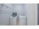 Laundry area with a washer, dryer, and wire shelving for organized storage at 5263 Bear Corn Run, Port Orange, FL 32128
