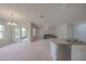 Open-concept layout connecting living room to the kitchen with stainless steel appliances at 5263 Bear Corn Run, Port Orange, FL 32128