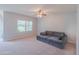 Cozy living room has natural light from a large window and a ceiling fan at 5263 Bear Corn Run, Port Orange, FL 32128
