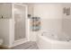 Bright bathroom showcasing a jacuzzi tub, and a glass-enclosed shower area, exuding a spa-like feel at 5300 S Atlantic Ave # 11302, New Smyrna Beach, FL 32169