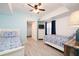 Comfortable bedroom featuring twin beds, a dresser, and light blue walls, offering a relaxing retreat at 5300 S Atlantic Ave # 11302, New Smyrna Beach, FL 32169
