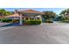Welcoming clubhouse featuring manicured landscaping, ample parking, and a well-maintained exterior, ideal for community gatherings at 5300 S Atlantic Ave # 11302, New Smyrna Beach, FL 32169