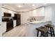 Modern kitchen featuring white cabinetry, stainless steel appliances, and stylish breakfast bar seating at 5300 S Atlantic Ave # 11302, New Smyrna Beach, FL 32169