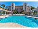 Inviting community pool surrounded by lounging areas and lush landscaping, perfect for relaxation and recreation at 5300 S Atlantic Ave # 11302, New Smyrna Beach, FL 32169