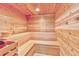 Inviting sauna with light wood interior, built-in benches, and a bucket for traditional heat control at 5300 S Atlantic Ave # 11302, New Smyrna Beach, FL 32169