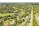 Aerial view showcasing homes nestled within a golf course community with lush greenery and mature trees at 544 Bottlebrush Ct, New Smyrna Beach, FL 32168