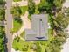 Aerial view showcasing the home's layout, lush landscaping, and circular driveway at 544 Bottlebrush Ct, New Smyrna Beach, FL 32168