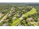 Aerial view of homes in a golf course community, lush with trees and greenery, in a desirable neighborhood at 544 Bottlebrush Ct, New Smyrna Beach, FL 32168