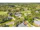 Expansive aerial view of a residential community near a golf course, lush with trees and greenery in a desirable location at 544 Bottlebrush Ct, New Smyrna Beach, FL 32168