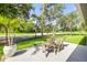 Cozy backyard patio with comfortable seating, manicured landscaping, and relaxing outdoor setting at 544 Bottlebrush Ct, New Smyrna Beach, FL 32168