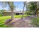 Beautiful backyard with mature trees, well-maintained lawn, covered patio, and peaceful outdoor setting at 544 Bottlebrush Ct, New Smyrna Beach, FL 32168