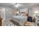 Bright bedroom featuring vibrant artwork, a ceiling fan, and comfortable furniture at 544 Bottlebrush Ct, New Smyrna Beach, FL 32168