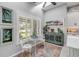 Cozy breakfast nook with plantation shutters, colorful rug, and natural light at 544 Bottlebrush Ct, New Smyrna Beach, FL 32168