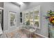 Bright breakfast nook featuring shuttered windows and colorful decor with door to exterior at 544 Bottlebrush Ct, New Smyrna Beach, FL 32168