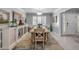 Elegant dining room with shuttered window, light wood table, and stylish sideboard at 544 Bottlebrush Ct, New Smyrna Beach, FL 32168