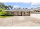 Inviting exterior featuring a well-maintained lawn, a large driveway, and an attached garage at 544 Bottlebrush Ct, New Smyrna Beach, FL 32168