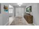 Inviting foyer featuring a decorative front door, tile floors, and a wooden console table at 544 Bottlebrush Ct, New Smyrna Beach, FL 32168