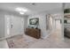 Bright foyer features tile flooring, a crystal chandelier and decorative wooden cabinet at 544 Bottlebrush Ct, New Smyrna Beach, FL 32168