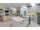 Open kitchen and living area features a large island, skylights and plantation shutters at 544 Bottlebrush Ct, New Smyrna Beach, FL 32168