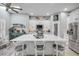 Open kitchen features a large island, barstool seating, white cabinets, and stainless steel appliances at 544 Bottlebrush Ct, New Smyrna Beach, FL 32168