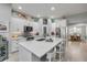 Modern kitchen with white cabinetry, sleek appliances, a spacious island, and easy access to the dining area at 544 Bottlebrush Ct, New Smyrna Beach, FL 32168