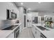 Bright kitchen features white cabinetry, stainless steel appliances, and a large island with a sink at 544 Bottlebrush Ct, New Smyrna Beach, FL 32168