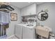 Functional laundry room featuring a washer, dryer, storage cabinets, and a utility sink at 544 Bottlebrush Ct, New Smyrna Beach, FL 32168