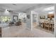 Spacious living room featuring tile floors, a skylight, and access to the dining area at 544 Bottlebrush Ct, New Smyrna Beach, FL 32168