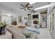 Bright living room features a modern ceiling fan, a painted brick fireplace, and comfortable seating arrangements at 544 Bottlebrush Ct, New Smyrna Beach, FL 32168