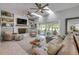 Cozy living area with skylights, fireplace, and sliding glass doors that open to outdoor seating at 544 Bottlebrush Ct, New Smyrna Beach, FL 32168