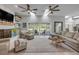 Comfortable living area featuring a fireplace, skylights, and a seamless transition to the outdoor patio area at 544 Bottlebrush Ct, New Smyrna Beach, FL 32168