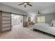 Spacious primary bedroom with a barn door leading to the bathroom and a bright window at 544 Bottlebrush Ct, New Smyrna Beach, FL 32168