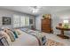 Bright main bedroom with a large window, a quilt-covered bed, and hardwood furniture at 544 Bottlebrush Ct, New Smyrna Beach, FL 32168