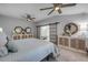 Serene main bedroom with dual ceiling fans, neutral tones, and sliding barn door to the main bathroom at 544 Bottlebrush Ct, New Smyrna Beach, FL 32168