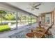 Covered patio with outdoor seating area and views of the landscaped backyard at 544 Bottlebrush Ct, New Smyrna Beach, FL 32168