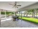 Spacious patio featuring dining set and views of well-manicured lawn and mature trees at 544 Bottlebrush Ct, New Smyrna Beach, FL 32168