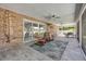 Relaxing screened patio with multiple seating areas and golf course views at 544 Bottlebrush Ct, New Smyrna Beach, FL 32168