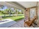 Outdoor patio with chairs looking out to a beautiful lawn and trees at 544 Bottlebrush Ct, New Smyrna Beach, FL 32168