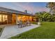Spacious rear brick patio with outdoor seating and serene views at 544 Bottlebrush Ct, New Smyrna Beach, FL 32168