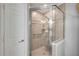 Shower with glass doors, neutral tile, and grab bar for accessibility at 544 Bottlebrush Ct, New Smyrna Beach, FL 32168