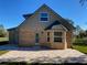 Rear view of brick home featuring an outdoor patio area and lush green lawn at 5832 Michelle Ln, Sanford, FL 32771