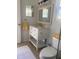Bathroom features a white vanity, with marble countertop and modern fixtures at 5832 Michelle Ln, Sanford, FL 32771