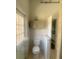 Bathroom featuring a toilet, cabinet and door to the outside at 5832 Michelle Ln, Sanford, FL 32771