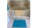 Tile-surround bathtub with neutral colored bathmat at 5832 Michelle Ln, Sanford, FL 32771