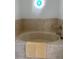 Tile-surround bathtub with neutral colored bathmat at 5832 Michelle Ln, Sanford, FL 32771
