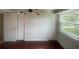 Bedroom showcasing modern lighting, dual closets, and a bright window at 5832 Michelle Ln, Sanford, FL 32771